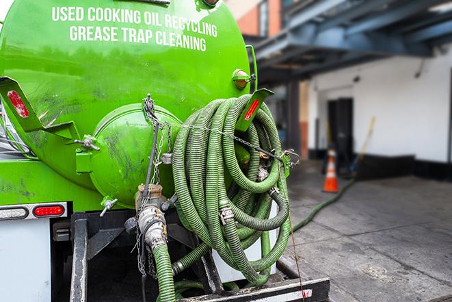 a grease trap being pumped by a sanitation technician in Marietta, PA